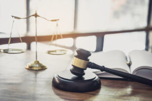 Picture of a gavel, a law book, and the scales of justice.