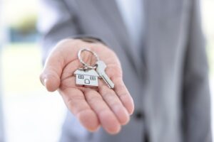 Picture of a real estate closing attorney holding a key on a house-shaped keychain.