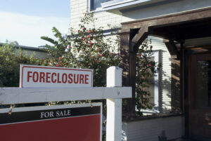 Picture of a foreclosure sale sign outside a house.