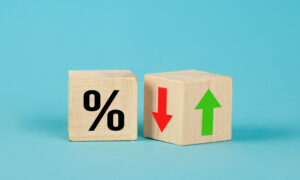 Picture of a wooden block with a percentage sign on its side, next to another wooden block with up and down arrows on its sides.