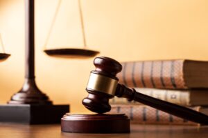 Picture of a gavel, the scales of justice, and a stack of law books.