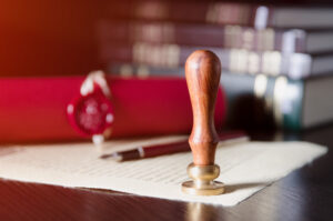 Picture of estate planning documents with a pen and a stamp.