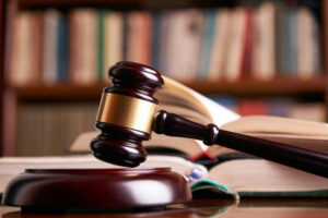 Picture of a judge's gavel with open law books in the background.