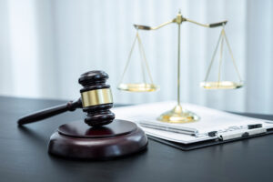 Picture of a gavel, the scales of justice, and a clipboard.